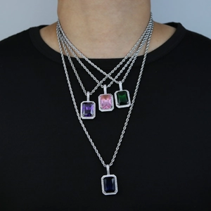 Detail of four hip hop necklaces with square pink blue purple and green crystal pendants