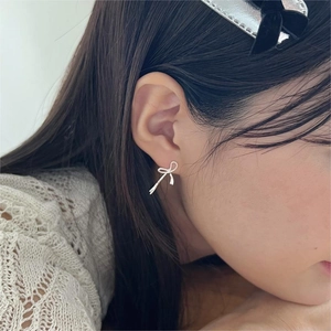 Elegant 925 sterling silver bow stud earrings shown on model for a minimalist style