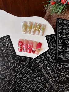 Christmas nail art stickers featuring reindeer and tree patterns with holiday nail tips