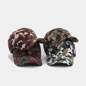 Detail of assorted camouflage corduroy baseball caps in woodland and desert tones
