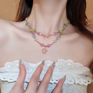 Double-layered beaded necklace with colorful glass flowers and teardrop pendant