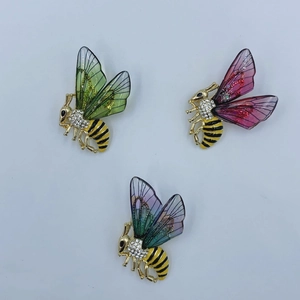 Three elegant gold-plated bee brooches with colorful wings and crystal rhinestones