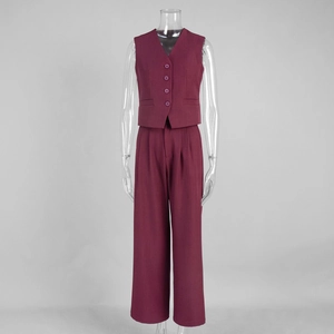 Detail of burgundy two-piece set featuring a tailored V-neck vest and wide-leg trousers