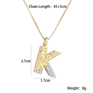 Macro detail of letter K pendant with measurements 2.7x1.7cm and zircon inlay
