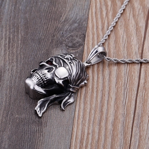 Vue macro d'un pendentif crâne de pirate avec pierre rouge sur fond de bois naturel