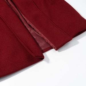 Close-up of wine red wool blend coat showing refined stitching and smooth inner lining
