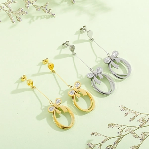 Elegant gold and silver bow stud earrings with sparkling crystals and oval links