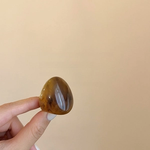 Close-up of vintage resin ring with amber tortoise shell texture and thick band design