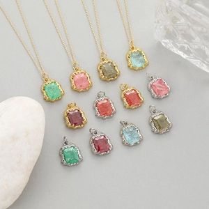 14K gold filled necklaces with colorful rectangular zircon pendants on stone display