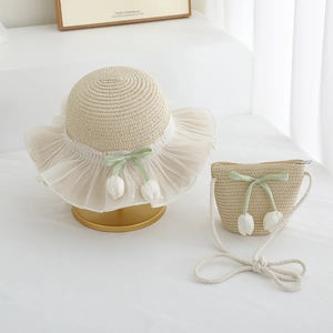 Detail of girls straw hat and crossbody bag set with white lace and tulip ribbon accents