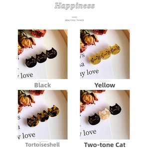 Detail view of cat-shaped acetate hair clips in black, glitter yellow, and tortoiseshell