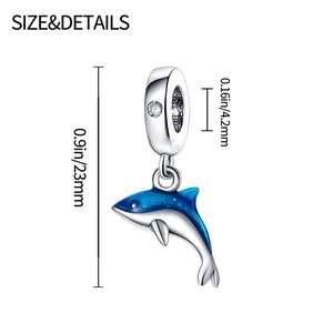 Detail view of silver dolphin charm with blue enamel and dimensions: 0.9in by 0.16in