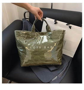 Close-up of green crinkled DuPont paper tote bag with white TOTE BAG text print