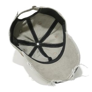 Detail view of washed cotton baseball cap showing internal stitching and adjustable buckle