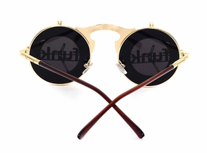 Detail view of steampunk flip-up sunglasses with gold metal frame and dark round lenses