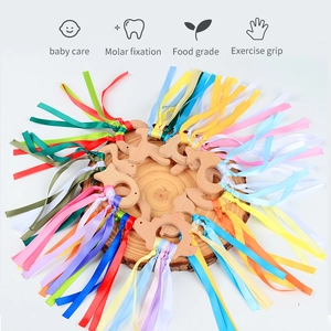 Colorful beech wood baby bird teether toy with vibrant silk ribbons for sensory grip play