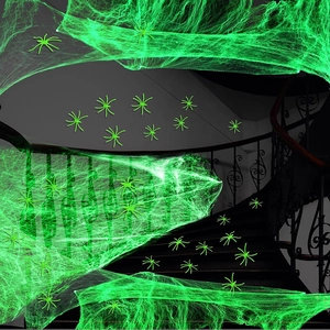 Luminous green Halloween spider web set with small plastic spiders for indoor decoration