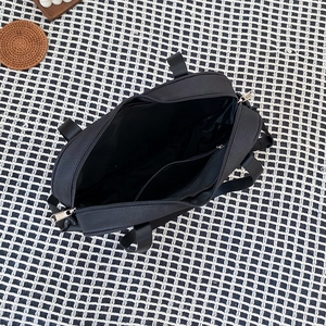 Top-down view of black nylon heart bag showing internal compartment and zipper closure