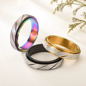 Macro shot of colorful sandblasted spinning rings in rainbow, gold and black finish