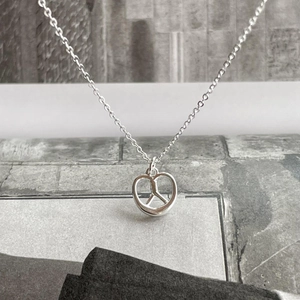 925 Sterling silver pretzel pendant necklace with metallic finish on minimalist background