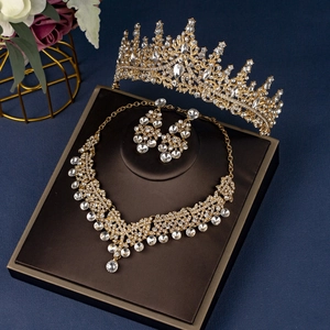 Exquisite bridal jewelry set with golden crystal tiara, necklace, and earrings on dark base