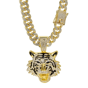 Detailed view of gold Cuban chain featuring a diamond-encrusted tiger head pendant