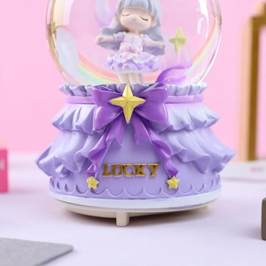Detail of purple musical crystal ball with lucky inscription and floating stars