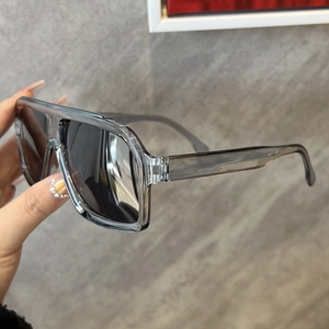 Detail of transparent grey oversized sunglasses frame and dark grey tinted lenses