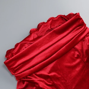 Detail of red velvet off-shoulder dress with 3D floral decoration and ruffled neckline