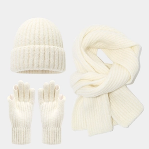 Detail view of cream-white knitted winter set showing ribbed texture on hat and scarf