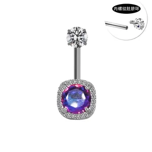 Detailed view of internal thread belly ring with purple crystal and white zircon stones