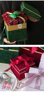 Macro view of velvet floral gift boxes with polka dots, golden frames and bows