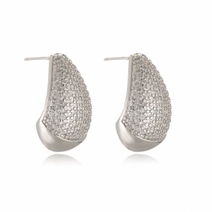 Macro shot of silver teardrop earrings featuring pavé cubic zirconia and polished finish