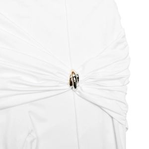 Close-up of white high-waist pants featuring a stylish gold and silver interlocking buckle