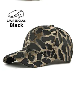 Detailed close-up of textured black and gold leopard pattern on a structured baseball cap