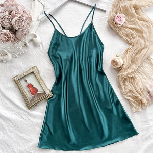 Elegant dark green satin slip nightdress with slim straps and V-neckline in a flat lay