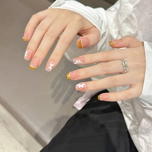 Handmade gradient nude pink press-on nails with white flowers and pearl accents