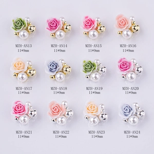 Close-up of 11x9mm resin rose nail charms in 12 colors with pearl and metal bead details