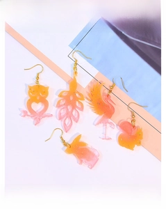 Detail of DIY animal resin earrings including owl, flamingo, and rabbit shapes with glitter