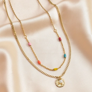 Detail of double-layer gold necklace with colorful beads and textured coin pendant