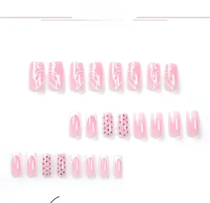 Detailed view of pink gradient press on nails with butterfly art and rhinestones