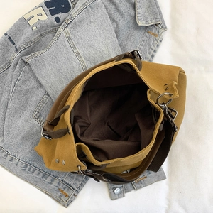 Large mustard yellow canvas tote bag with spacious interior shown on blue denim jacket
