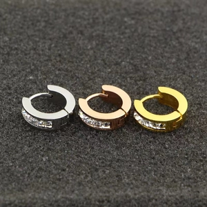 Detailed macro view of three pairs of sparkling rhinestone titanium steel hoop earrings