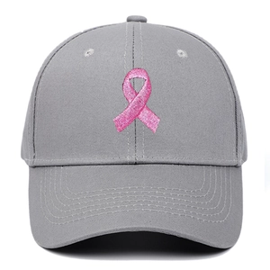 Detailed close-up of pink ribbon embroidery on a grey structured cotton baseball cap