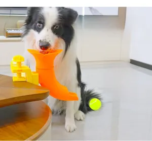 Close-up of the adjustable clamp and yellow slide of the pet interactive ball launcher