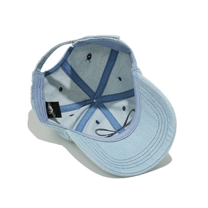 Detail view of denim baseball cap interior with stitching and adjustable strap