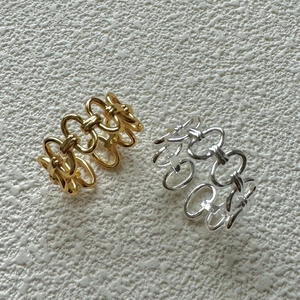 Detailed view of interconnected chain rings in polished gold and silver metal finishes