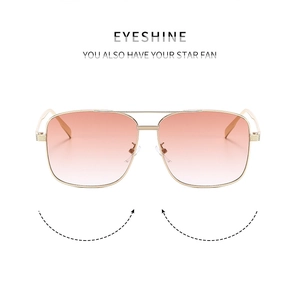 Detailed close-up of square double-bridge sunglasses with orange gradient lenses