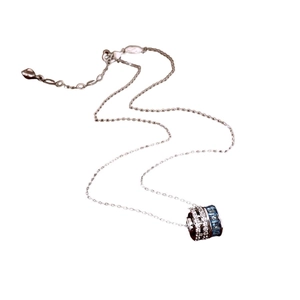 Silver cylinder pendant necklace with blue and white zircons on a white background