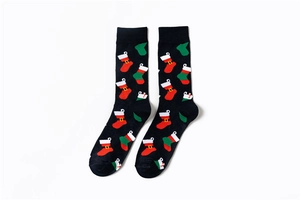 Detailed knit texture of Christmas crew socks with festive red sock patterns on black cotton